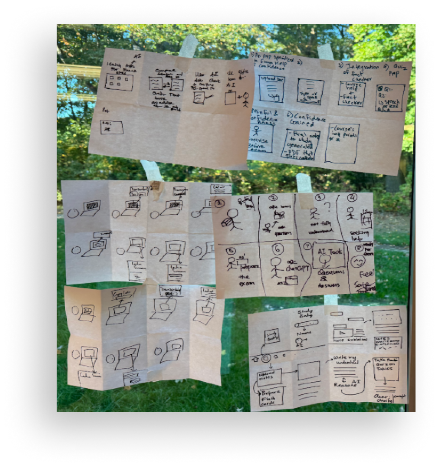 Lo-fi storyboards and sketches taped up during ideation
